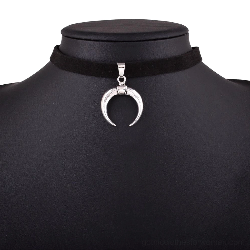 Close-up macro shot of zinc alloy crescent moon pendant showing silver-tone metal finish and detailed carving