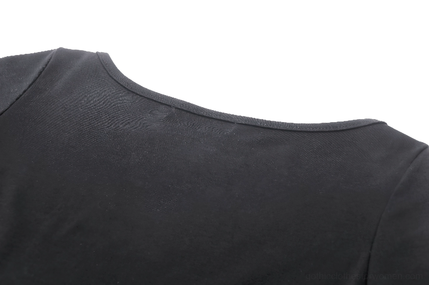 Macro close-up of crew neck and smooth matte black fabric texture