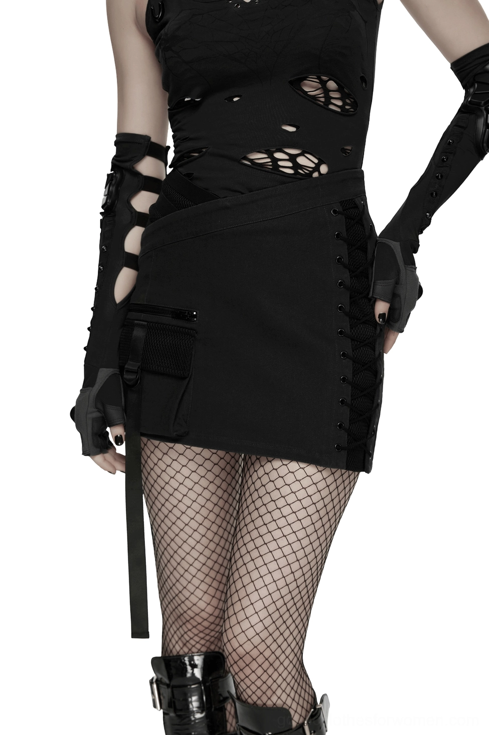 Black asymmetrical cyberpunk bodycon mini skirt with lace-up side panel and utility pocket worn by goth punk model, side rear three-quarter view