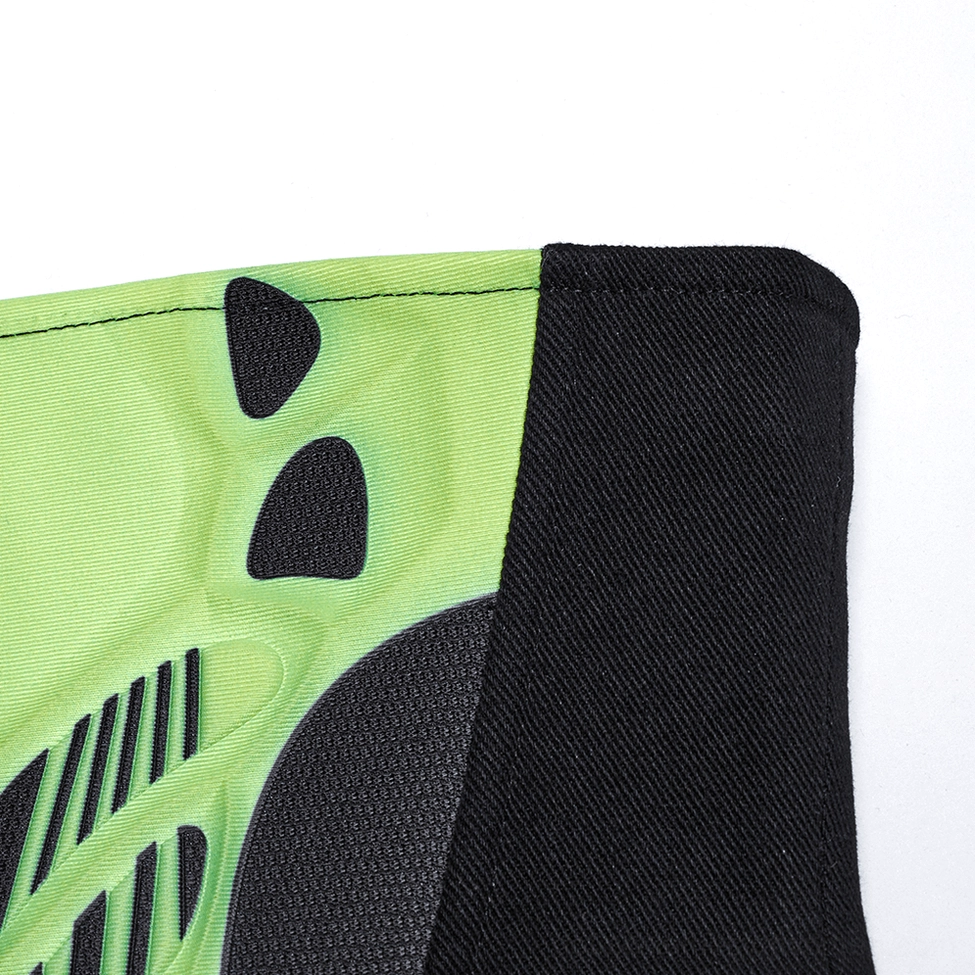 Macro close-up of cyberpunk corset side panel showing neon green textured armor accent on black woven fabric