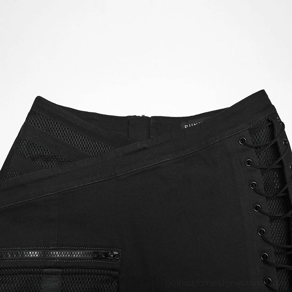 Cyberpunk black mini skirt waistband close-up showing crossover asymmetrical design with metal lace-up eyelets and zippered pocket detail
