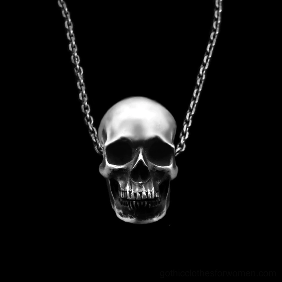 Vintage silver skull pendant necklace frontal shot on black background highlighting sharp anatomical detail and gothic aesthetic