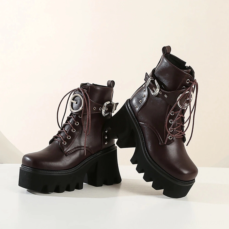 Pair of dark brown gothic platform combat boots with smooth leather finish and detailed buckle lacing, front low angle view
