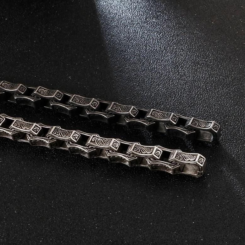 Dark gray antique finish gothic engraved bracelet flat lay showcasing matte stainless steel aesthetic