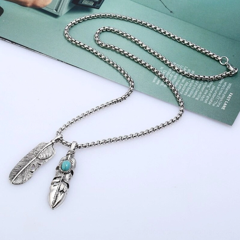 Delicate dual feather mini gothic pendant necklace - tiny turquoise accents with box chain on desktop setup