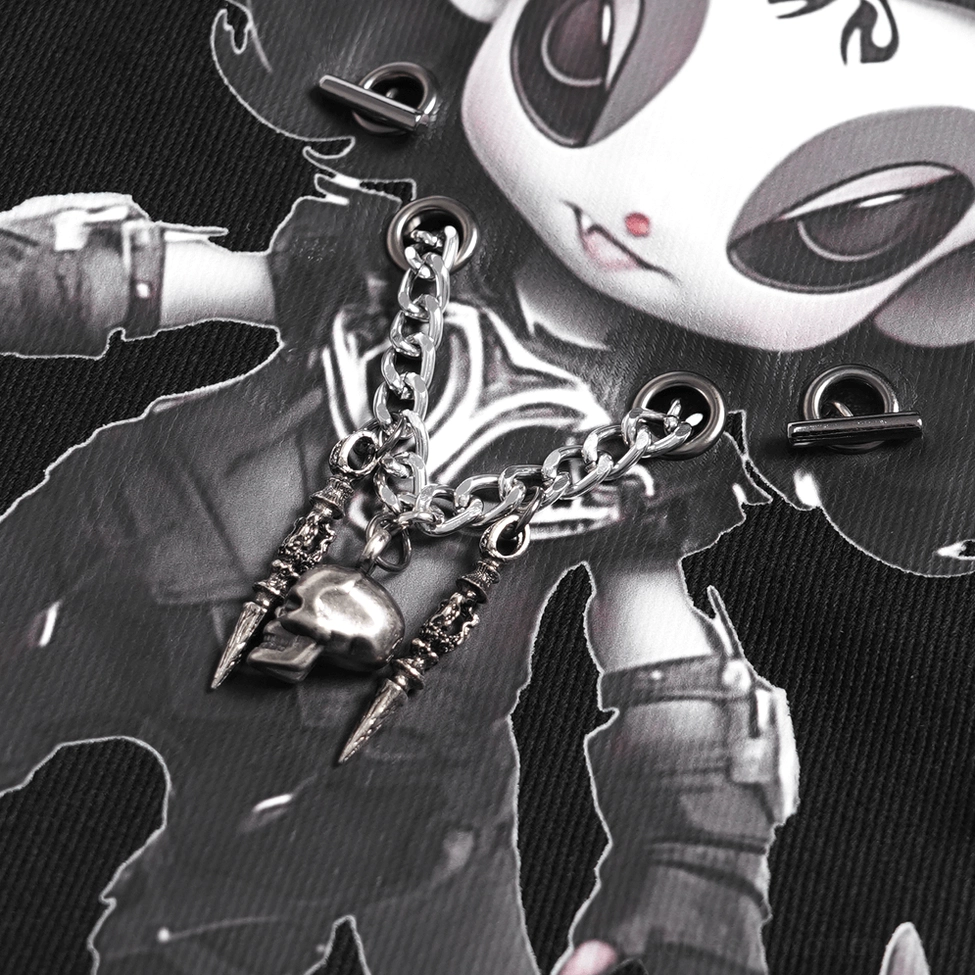 Close-up of demon backpack printed artwork showing detailed demon character illustration and metal chain charm