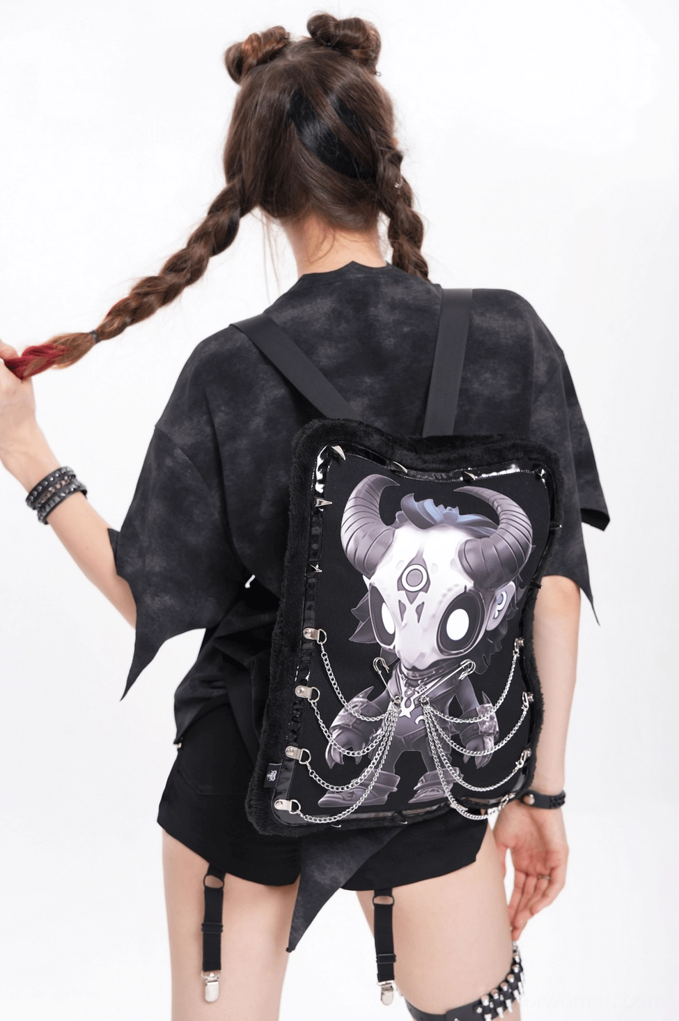 Three-quarter angle view of gothic demon skull backpack on model in dark streetwear styling, emphasizing alternative fashion aesthetic and wearability