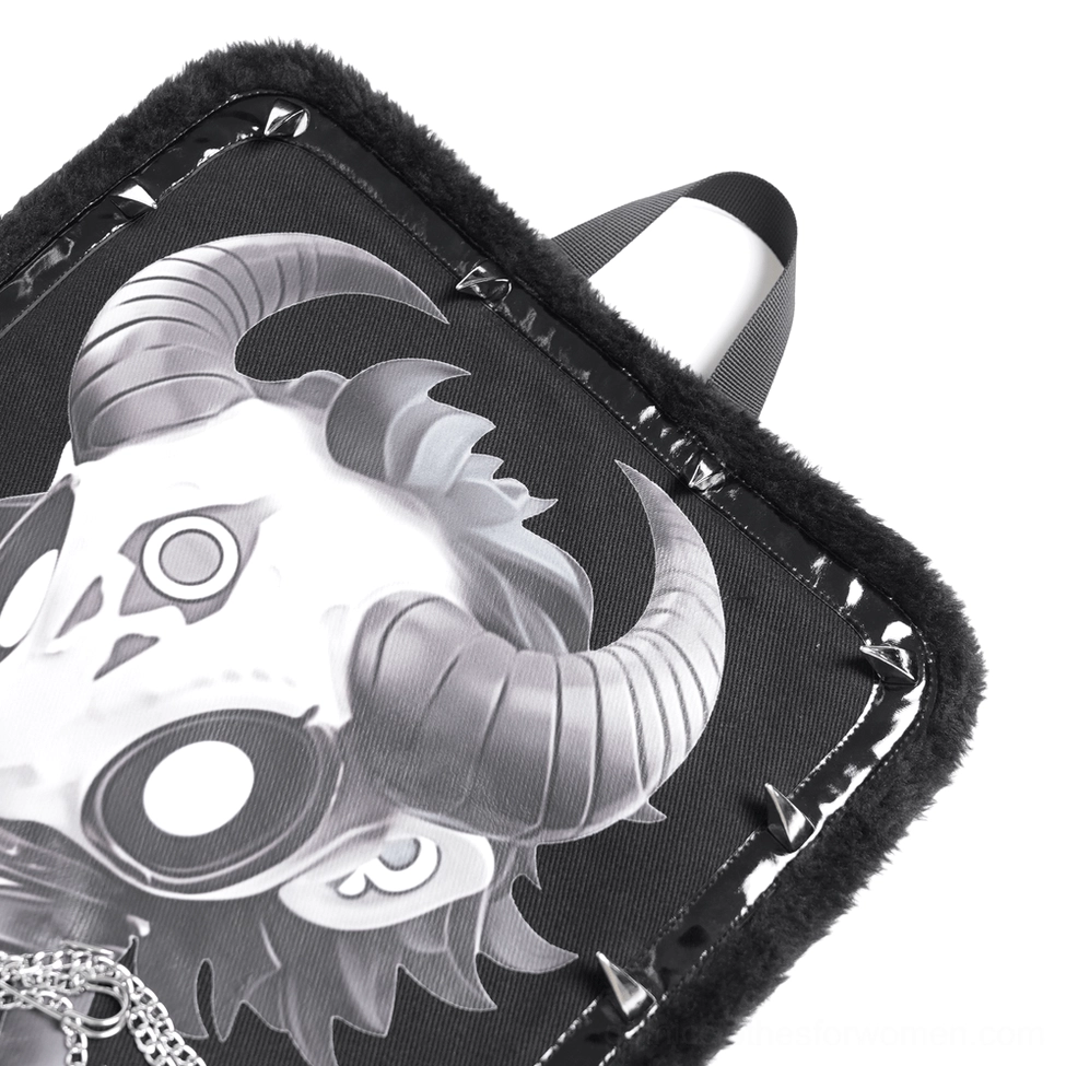 Magnified view of demon skull print on gothic backpack front panel showcasing cartoon artwork, fur trim and metal rivet embellishments