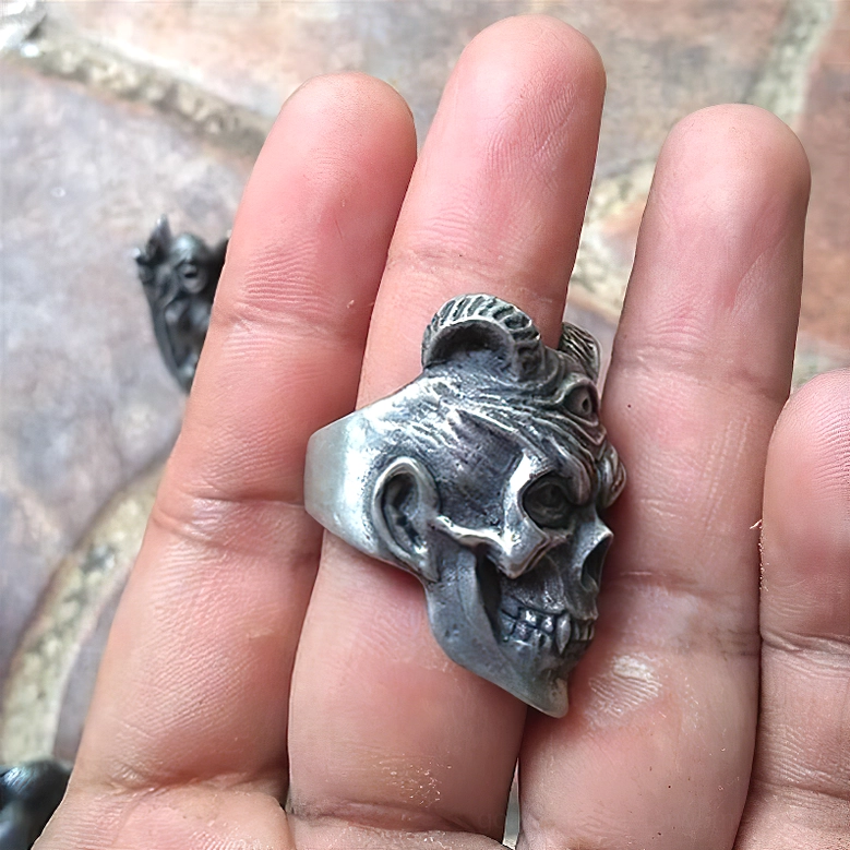 Side profile of demon skull ring showing visible skull jaw, ear details and polished silver band