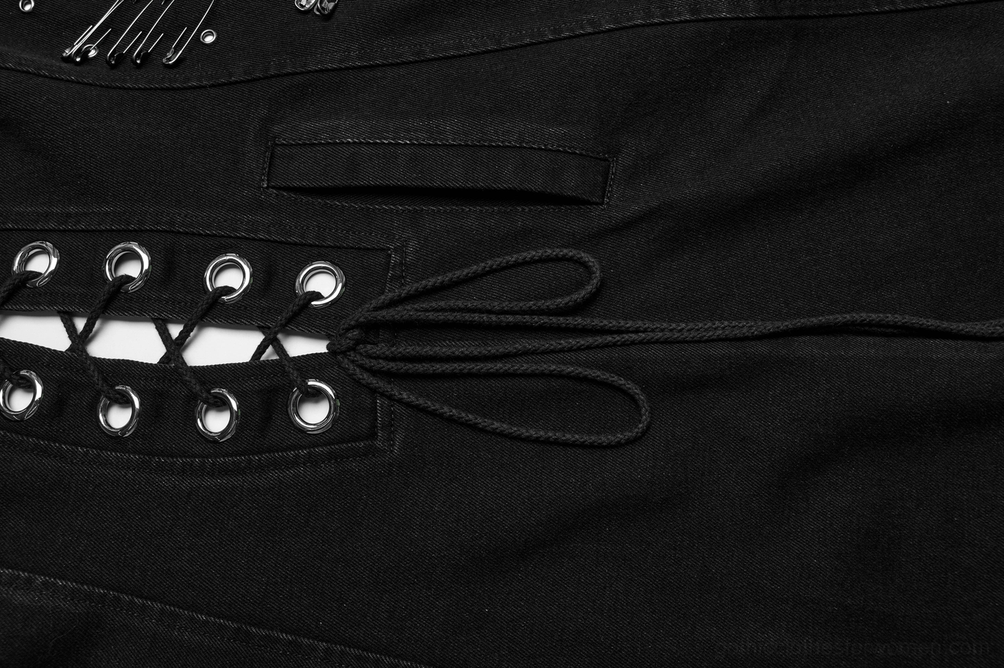 Black denim cape texture and fabric detail, washed denim material composition, craftsmanship quality