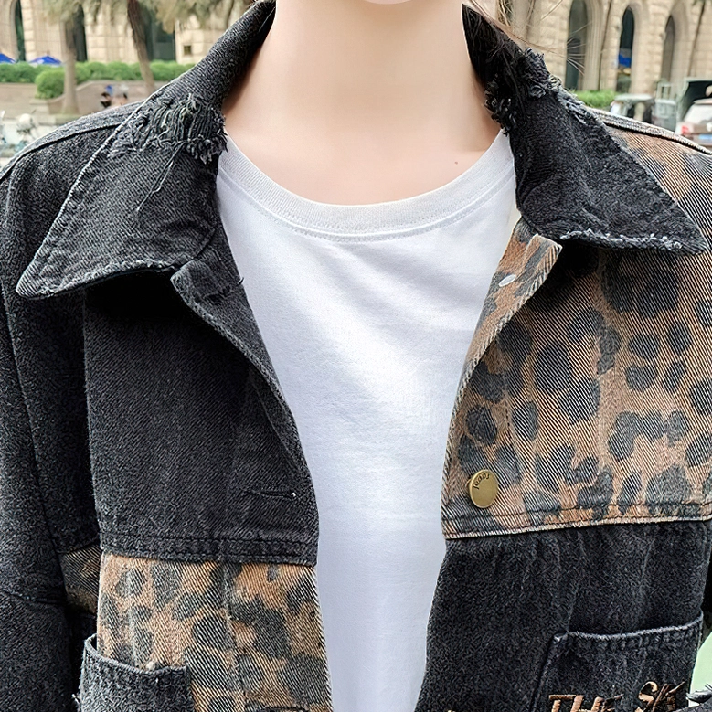 Denim jacket collar and button details close-up, showing leopard print panel and metal snap fasteners