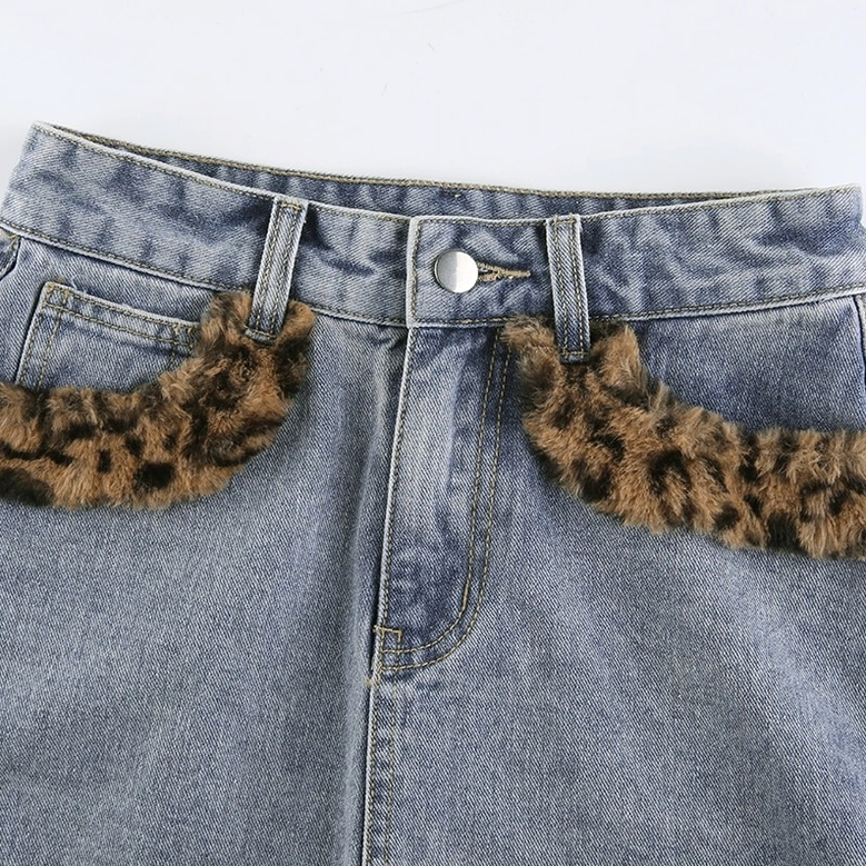 Denim mini skirt side profile view, high-waisted cut with leopard fuzzy accents