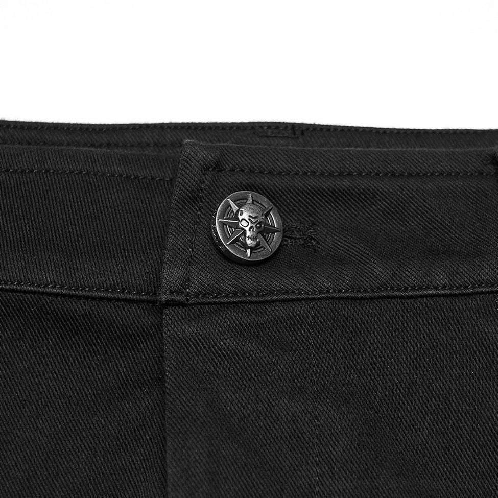 Close-up of shorts waistband with skull embossed metal button and twill denim fabric texture
