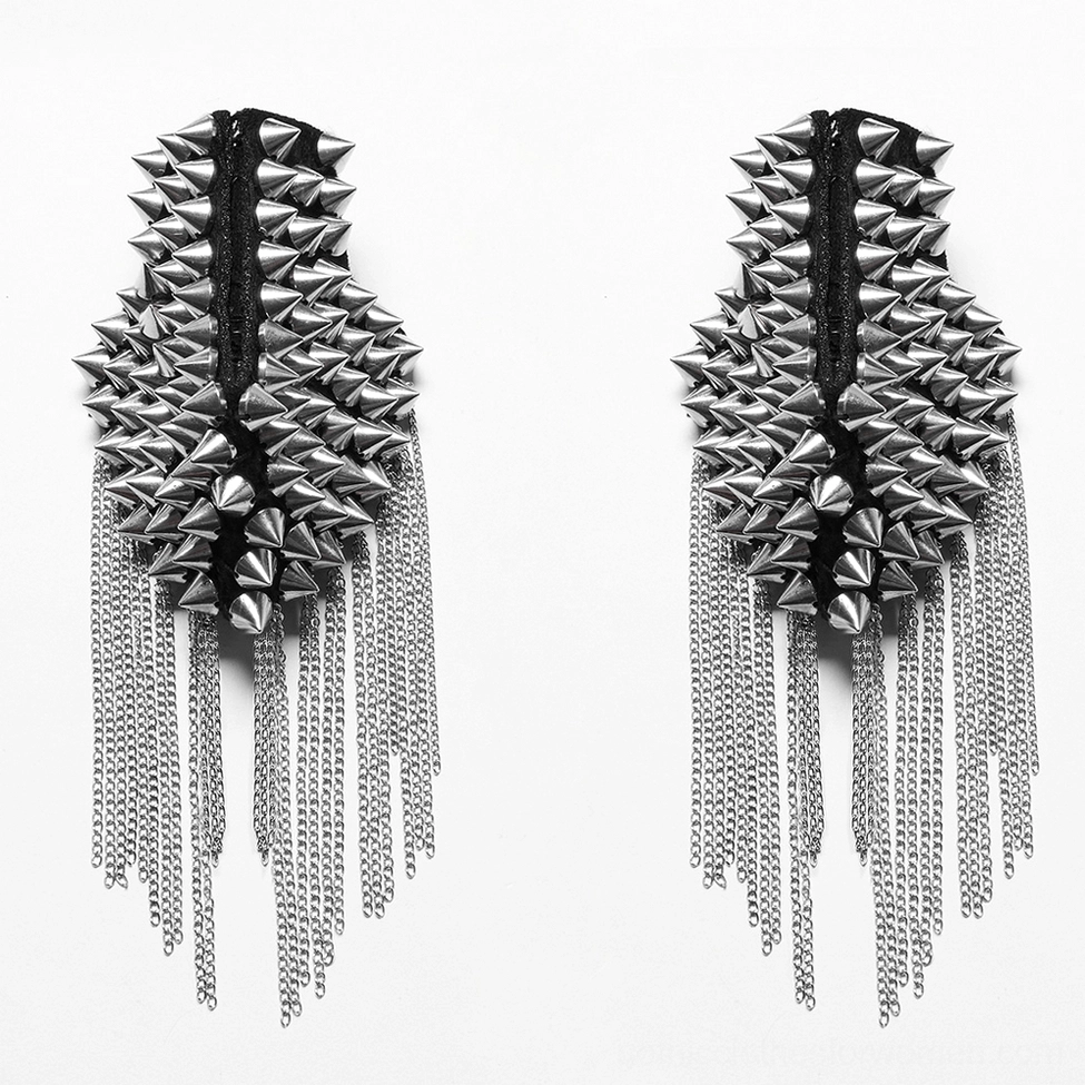 Detachable metal spiked shoulder harness pads, flat lay detail showcasing chain tassel trims and metal stud construction