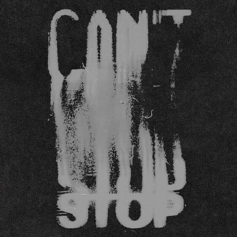 Close-up of faded grey distressed CAN'T STOP graphic print on black cotton