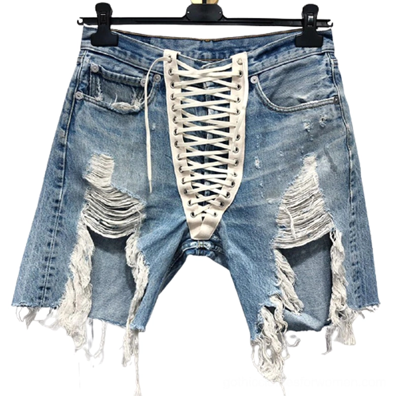 High-waist distressed denim shorts with white lace-up front closure displayed on hanger, flat lay view showing detail