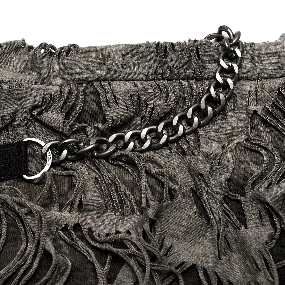 Distressed fabric and chain close-up detail showing metal curb chain attached to ripped knit fabric with D-ring clasp
