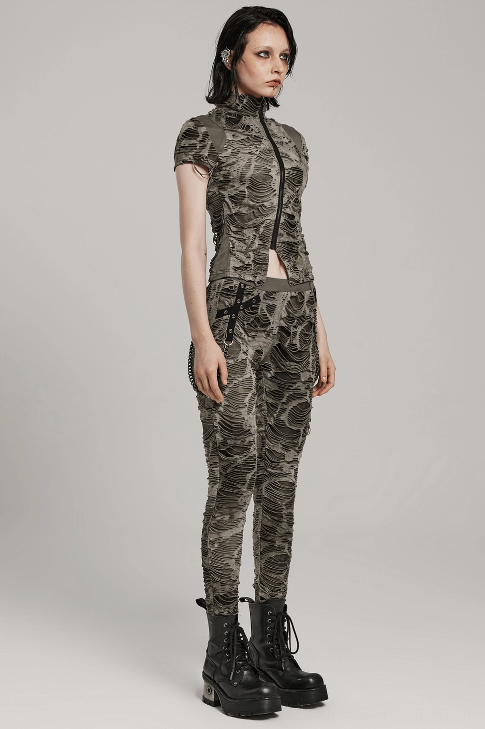 Distressed gothic trousers product close-up emphasizing architectural ripping pattern and multi-layer mesh design