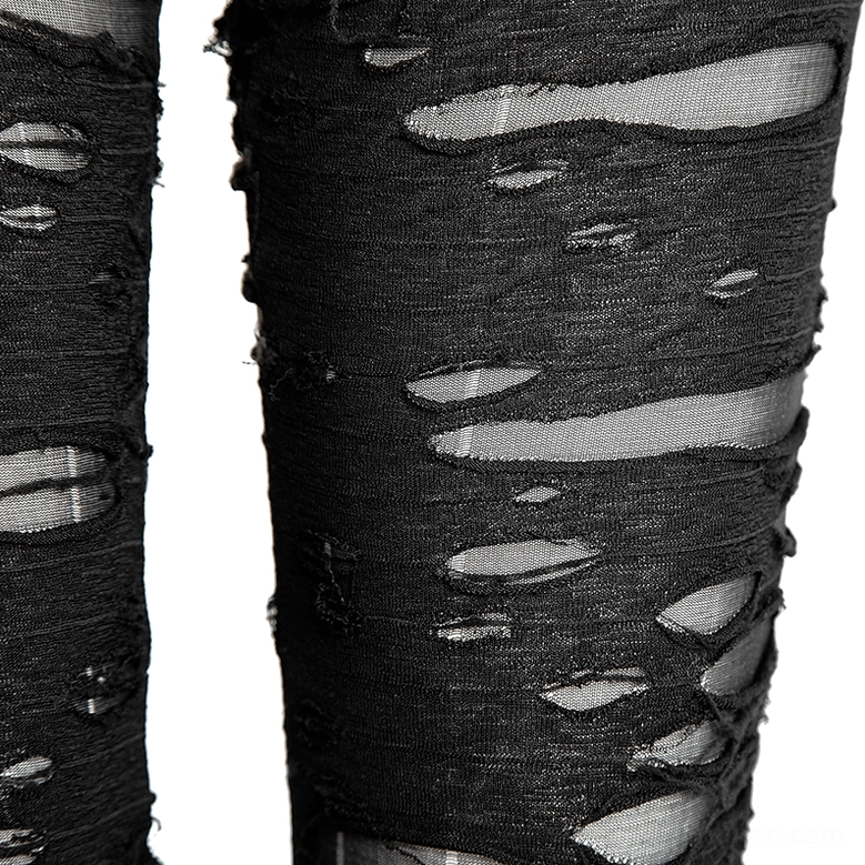 Extreme close-up of distressed black knit fabric with frayed holes and mesh underlayer