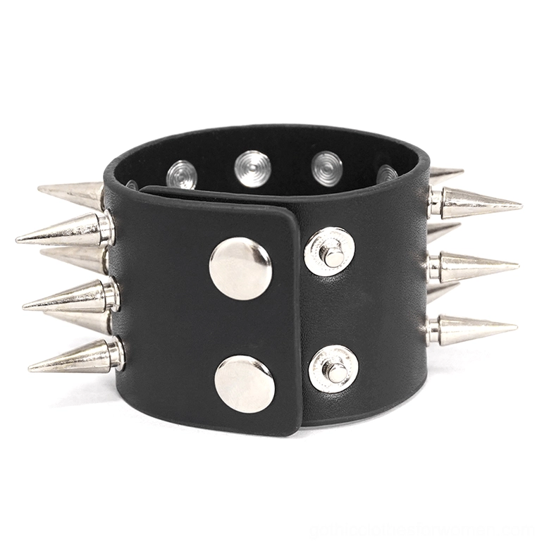 Double-row wide spiked black leather cuff bracelet close-up, showing metal snap buttons and full spike coverage from front view