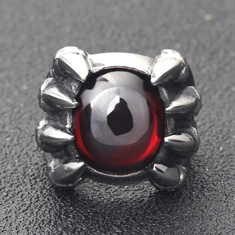 Dragon claw ring top view showing red stone setting, geometric claw prongs, polished metal frame