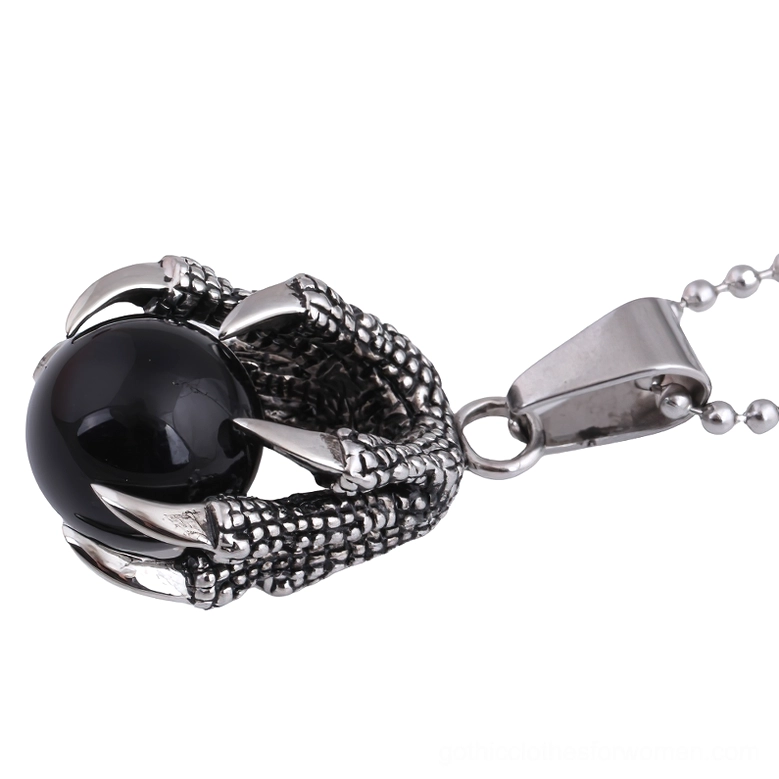 Dragon claw pendant side profile showing intricate stainless steel claw texture and black crystal setting