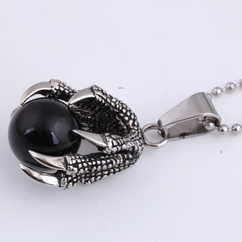 Dragon claw pendant side view detail showing scaled textured metal work and retro silver finish