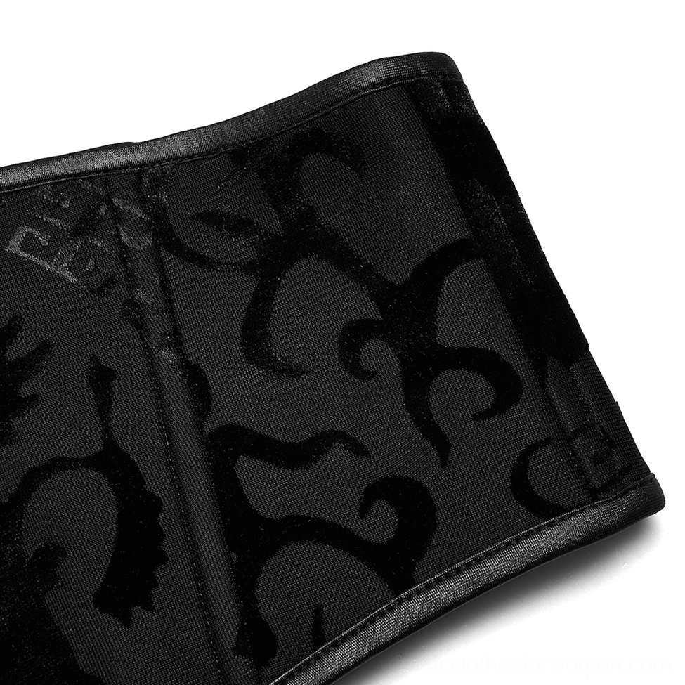 Close-up detail of dragon corset belt showing raised velvet dragon and geometric pattern with leather edge binding