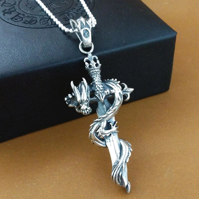 Medieval dragon sword gothic pendant - front view with crowned hilt detail on embossed black jewelry box background
