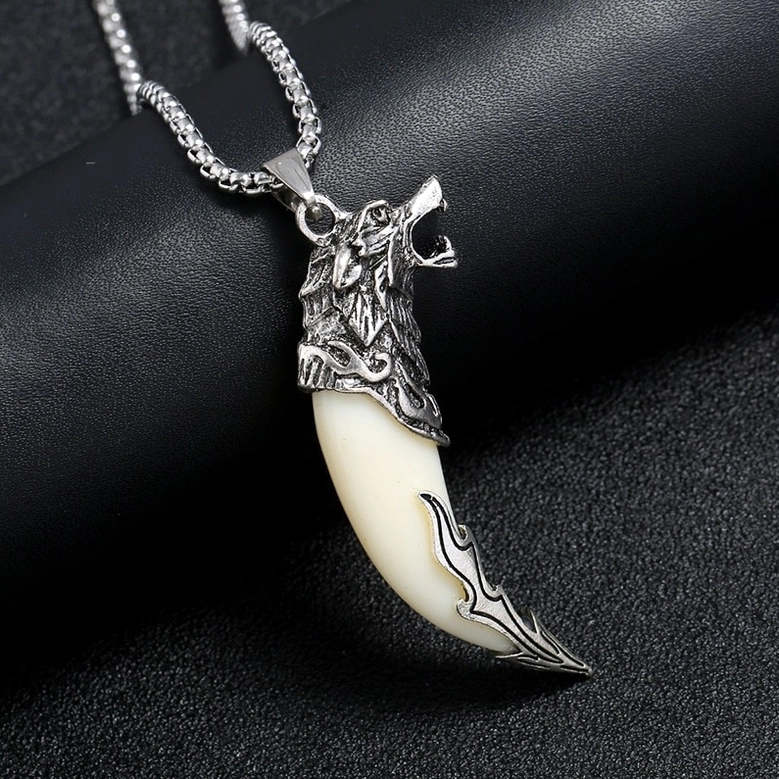 Dragon head wolf tooth necklace close-up side view on black leather - intricate metal carving detail photography