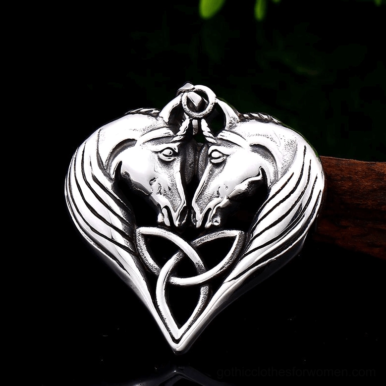 Polished silver stainless steel dual horse heart gothic pendant on dark background, top-front close-up showing mirror-like finish and equestrian symbolism