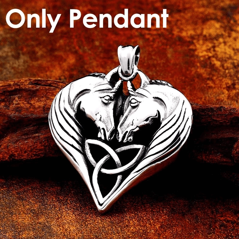 Solo heart pendant with dual horse motif on dark wood background, gothic jewelry close-up highlighting carved mane texture and symmetrical design