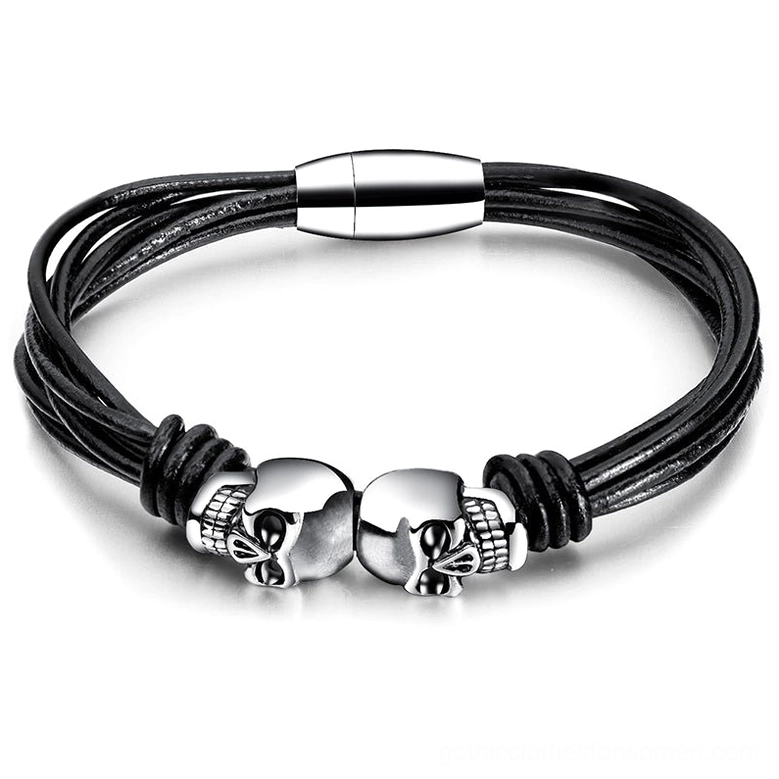 Dual skull black gothic bracelet flat lay top view showing stainless steel charms and leather cord design