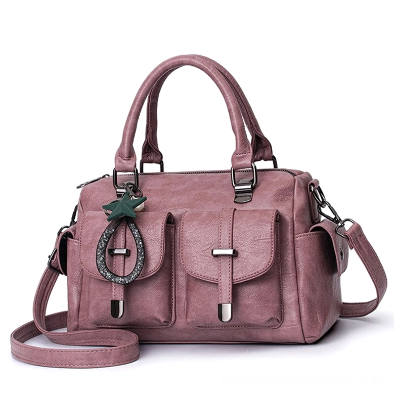 Dusty pink romantic gothic leather handbag with star charm, interior zipper pocket, and top handles