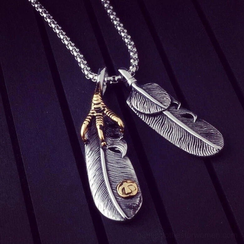 Eagle claw feather gothic necklace angled view - vintage gold eagle claw charm with feather details on wood background