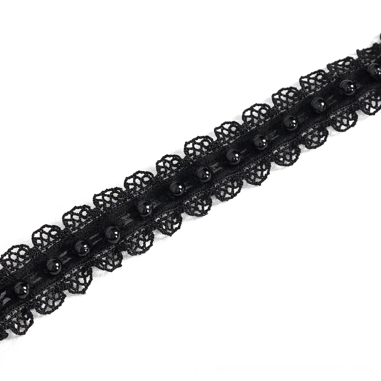 Embellished lace edge and ruffled trim - close-up of gothic dress decorative elements