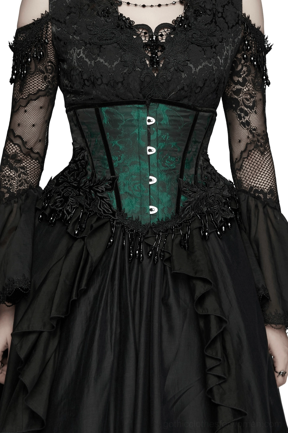 Emerald green jacquard gothic underbust corset with black beaded tassel trim, modeled on female in front three-quarter view wearing complete outfit with black mesh sleeves