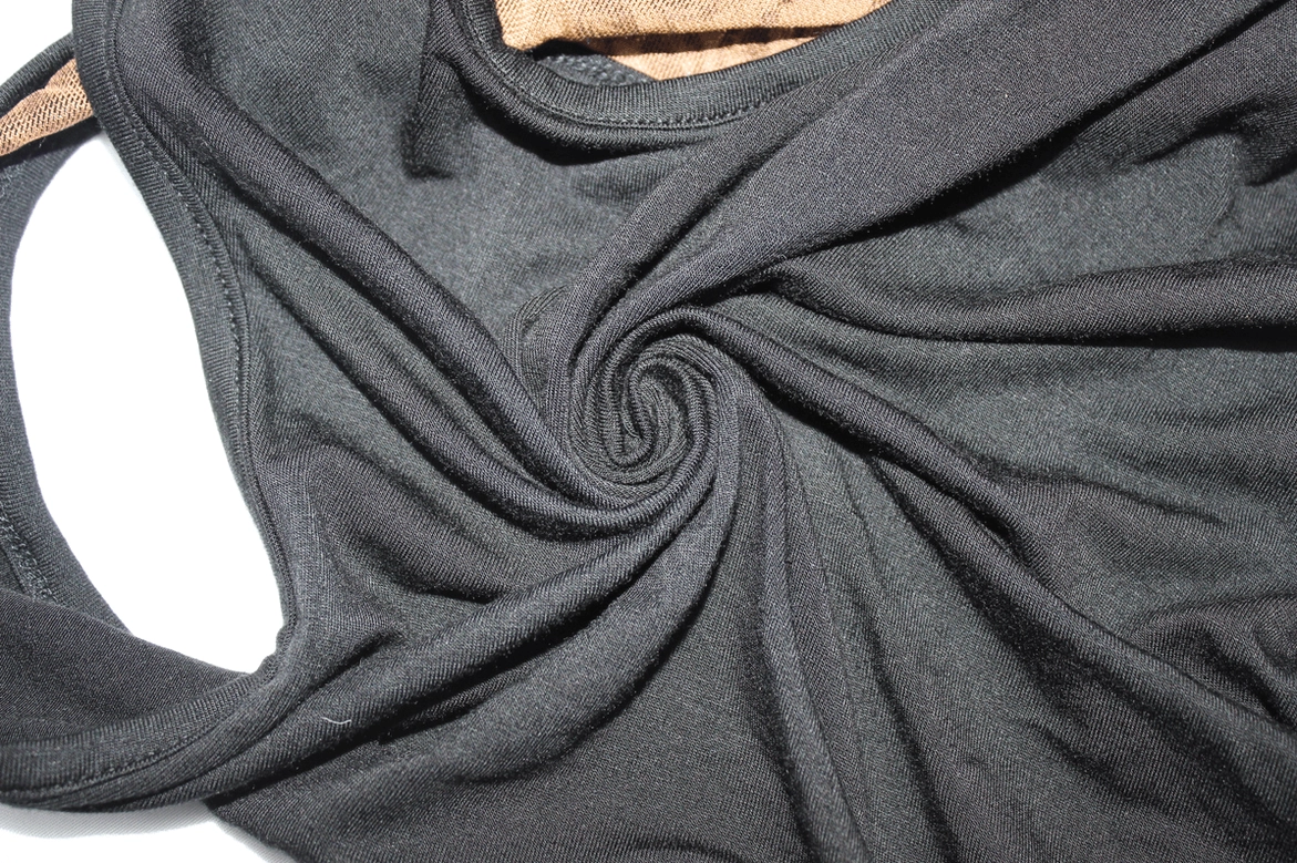 Black polyester knit fabric texture with precision stitching - fabric quality detail shot