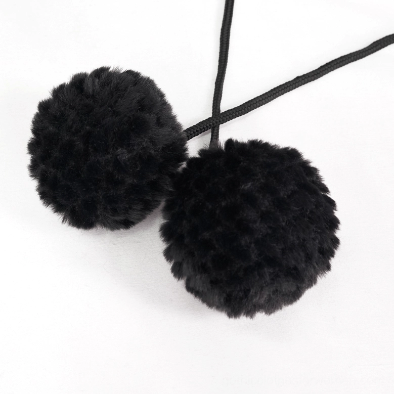 Black faux fur pom-pom set close-up showing fluffy texture and attached drawstrings for gothic cape