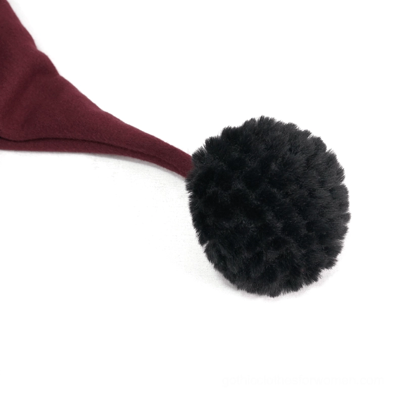 Single black faux fur pom-pom close-up side view connected to drawstring for gothic hooded cape