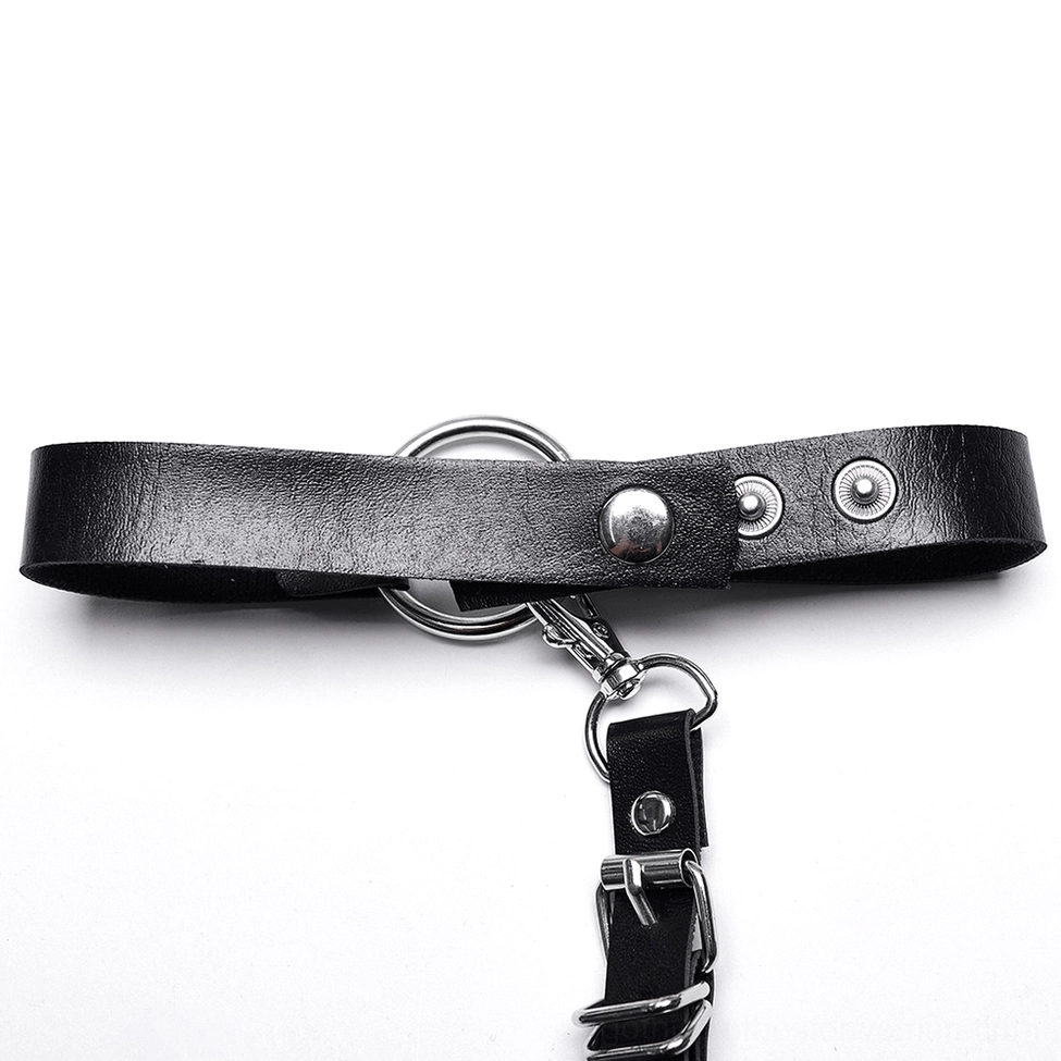 Close-up detail of black faux leather harness strap hardware with metal O-ring and detachable clasp mechanism