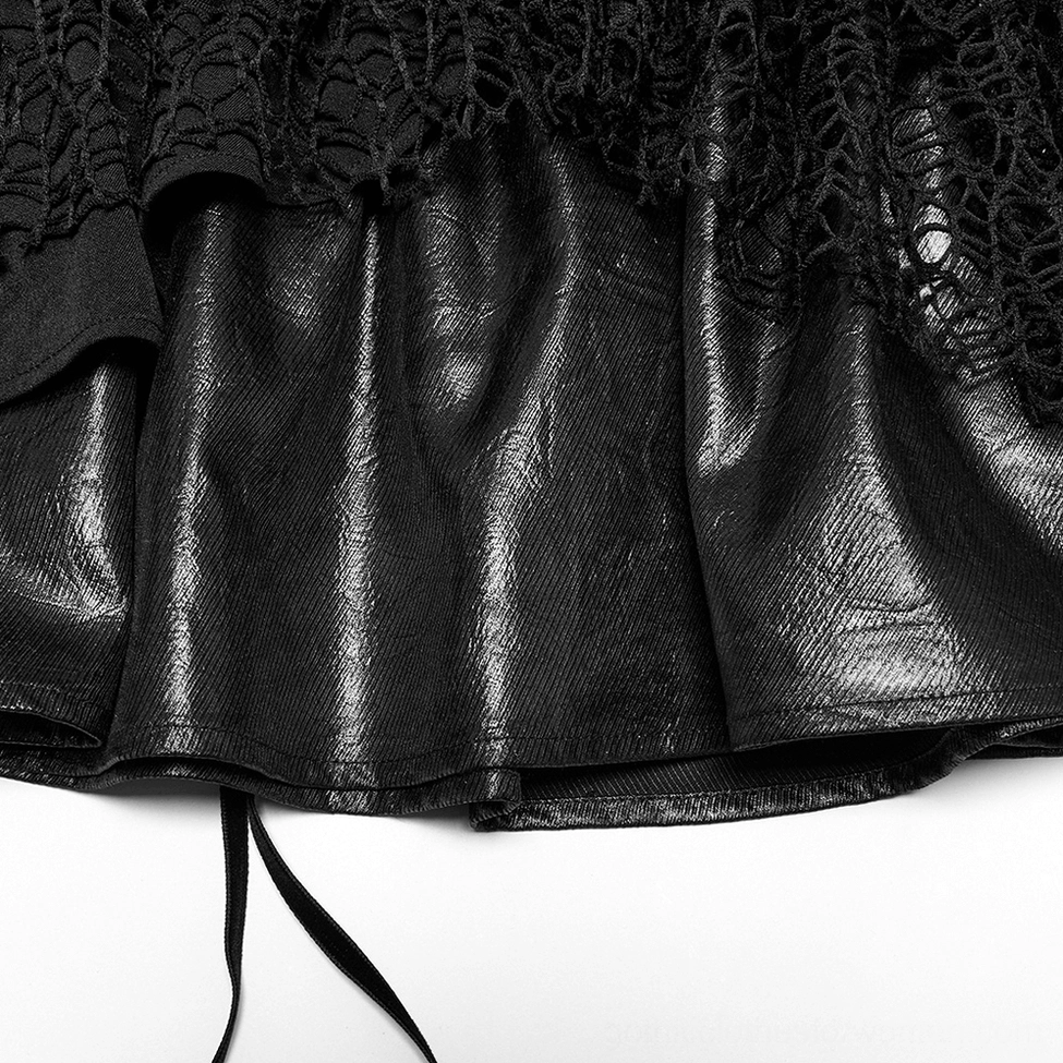 Faux leather and mesh fabric close-up of black gothic mini skirt showing shiny leather texture with ruffled lace trim detail