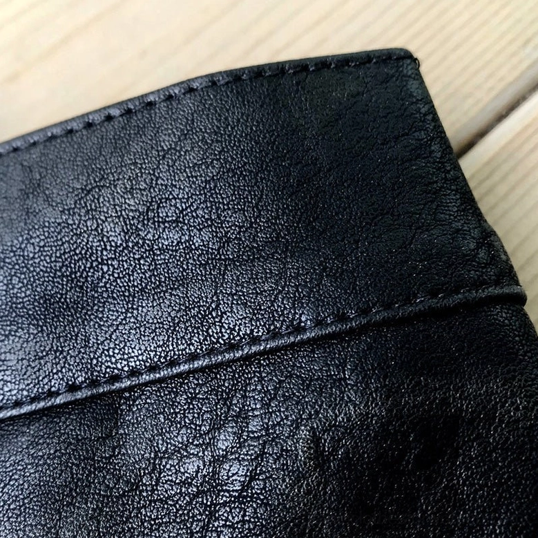 Premium faux leather texture detail of gothic shorts showing pebbled surface and precision stitching