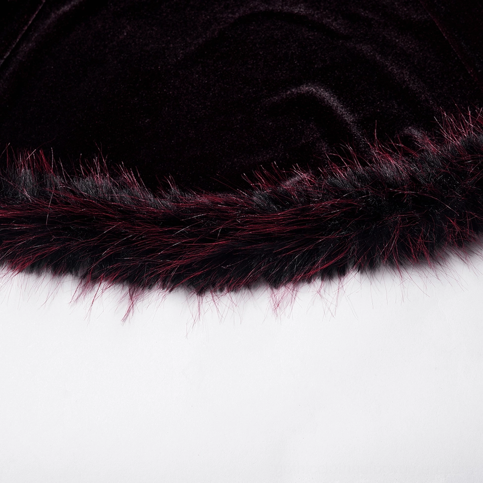 Feather trim detail on wine red velvet gothic dress hem close-up texture