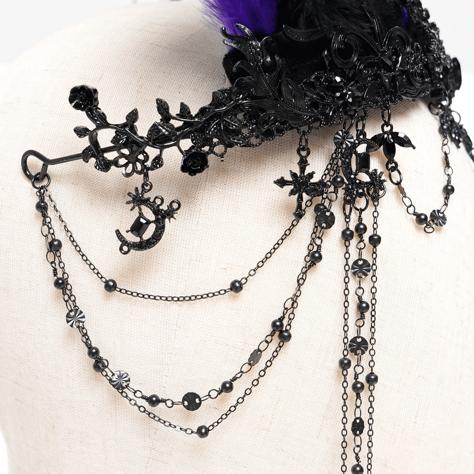 Gothic feathered crown with cross pendants detailed view showing metalwork and feather arrangement on mannequin