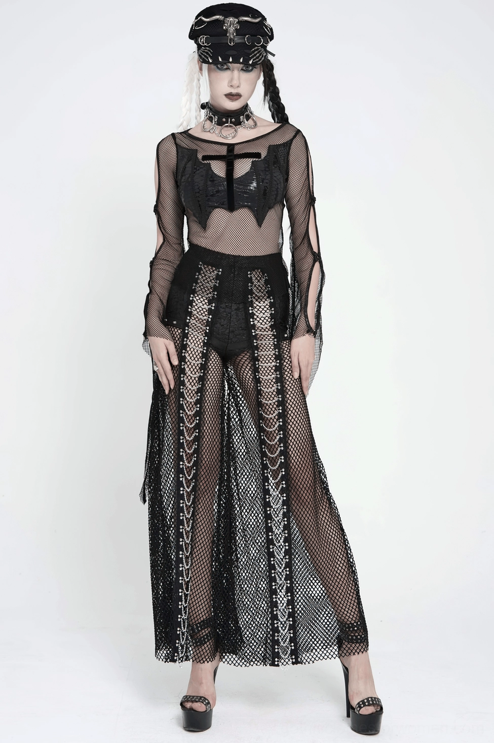 Detail of sheer mesh panels and solid black fabric construction on gothic fishnet flare pants