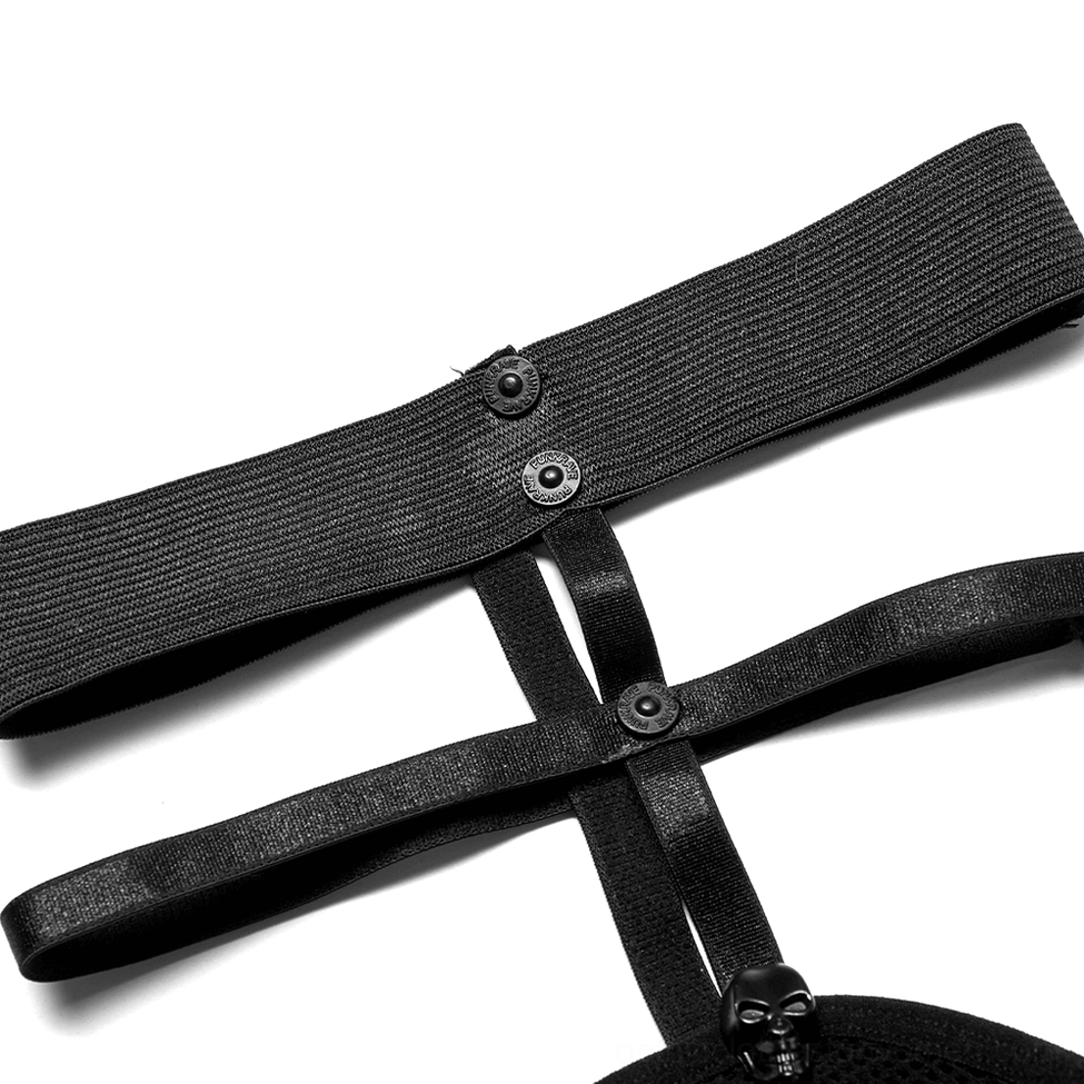 Close-up detail of garter strap hardware and elastic bands on black fishnet socks with metal rivet construction