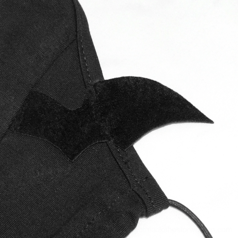 Extreme close-up of black flocked bat wing embellishment showing texture and stitching on gothic mask