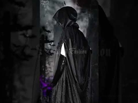 Side back view of all-black floor-length hooded gothic cloak worn outdoors in dark gothic setting