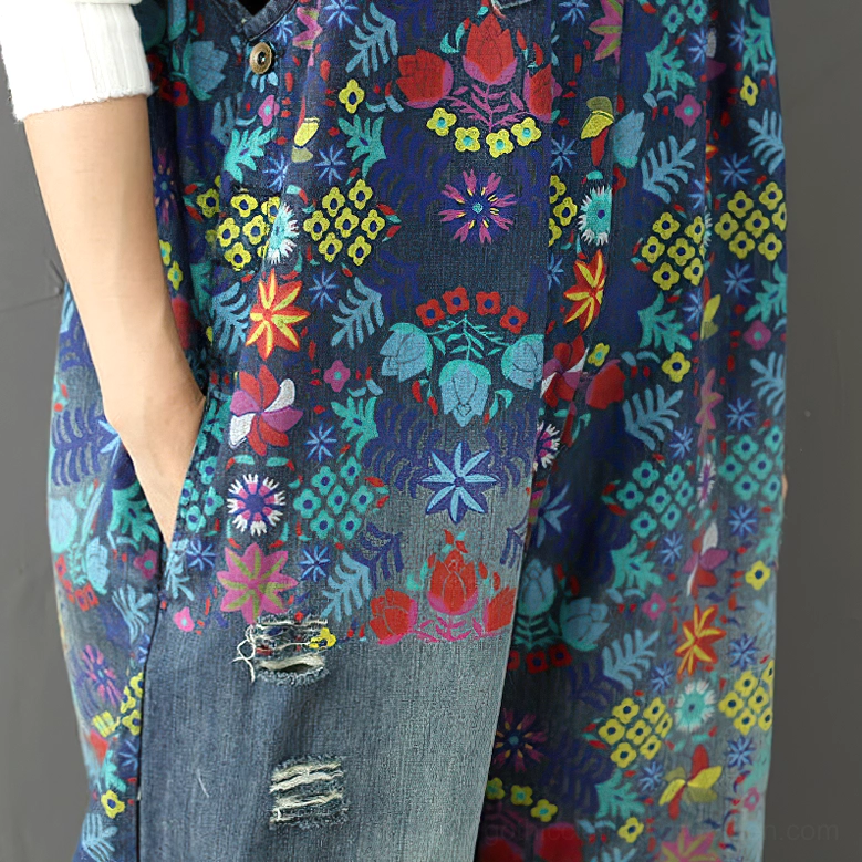 Additional detail view of floral-printed denim wide-leg overalls showcasing botanical pattern and vintage distressed construction